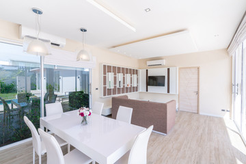 house or home building Luxury interior design in living room of pool villas. Airy and bright space with high raised ceiling and  dining table
