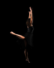 Fototapeta premium Girl ballet dancer on black background