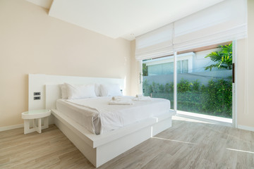 real Luxury Interior design in bedroom of pool villa with cozy king bed with high raised ceiling home, house ,building