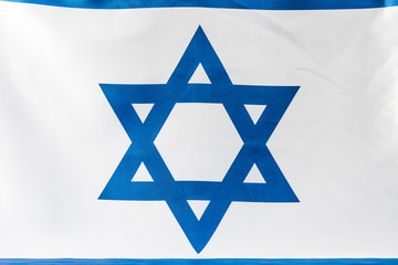 close up of blue star of david on national flag of israel