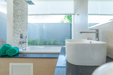 Luxury bathroom features basin  bathtub.