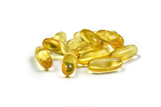 Close up of fish oil capsules isolated on white background. Supplementary food background. Omega 3. Vitamin E.