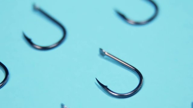 lots of fishing hooks on blue background. fishing accessories and accessories