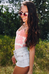 Fototapeta premium Sexy girl in shorts in the summer outdoors.Girl smiling on vacation