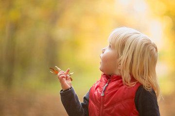 young girl with autumn leaf