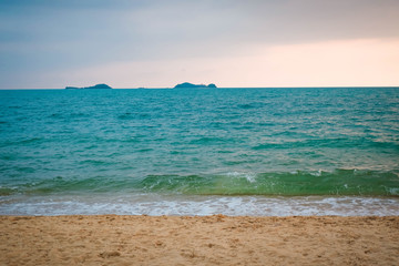 Sunset on the beach sea with cloud yellow sky background in the summer