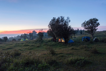 Camping tent tourist on hill mountain and sunrise background