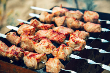 Meat skewers being grilled in a barbecue