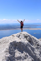Woman is standing on the summit and feel free
