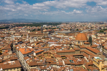 A sweeping view of the skyline and rooftops of Florence from the top of Giotto's bell tower, next to the cathedral, looking out towards the main railway station.