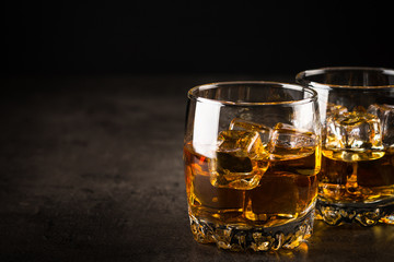Whiskey in the glasses on black.