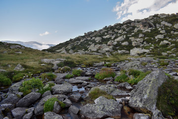 A stream surrounded by rocks near the lake Les Abelletes, in the town Pas de la Casa, Andorra