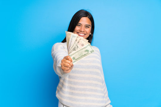Young Colombian girl with sweater taking a lot of money