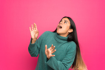 Young Colombian girl with green sweater nervous and scared