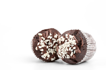 Tasty chocolate cupcakes on white background. Chocolate caramel cupcake and butterscotch syrup. Chocolate cupcake isolated on white.