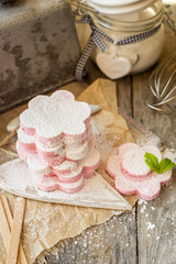 Homemade pink  marshmallow in flowers shape on a rustic background
