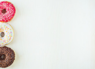 Donuts with icing on white background. Top view