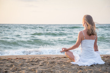Fototapeta na wymiar Woman meditating at the sea