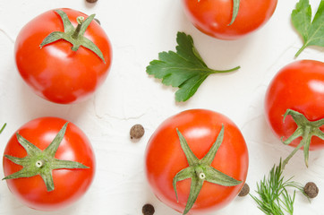 Raw tomatoes, herbs and black pepper on a light concrete background. Top view with copy space. - Image