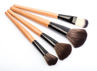 Various makeup brushes isolated over white. wooden makeup brushes. Duo fibre foundation makeup brush. Style. Fashion. Visage. Cosmetics.