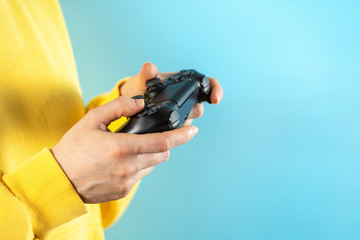 Young girl holding black joystick in her hands