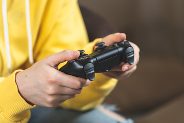 Young woman holding modern joystick in her hands