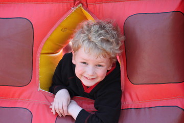 Portrait of little boy on a bouncy castle