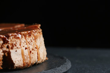 pie with caramel close up on dark background. cake with banana and caramel