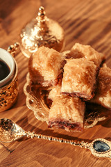 Turkish sweets with coffee on a wooden table