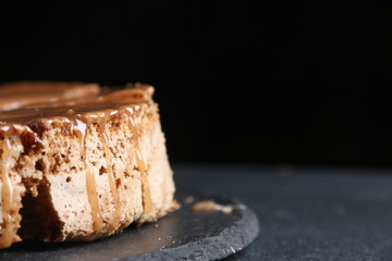 pie with caramel close up on dark background. cake with banana and caramel