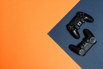Photo of modern black gamepad lying on dark background