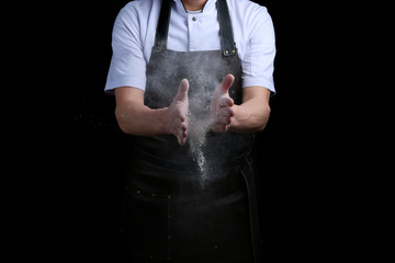 hand clap of chef with flour on black background isolated