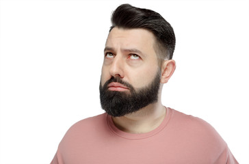 Obraz premium A cute young bearded man in pink shirt shows emotionally happy