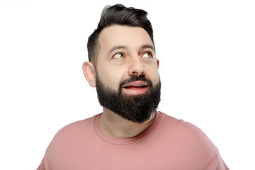 Obraz premium A cute young bearded man shows emotionally