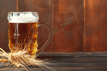 Glass beer on wood background