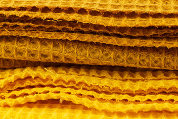 Yellow corrugated cotton textile - close up of fabric texture. Cotton Fabric Texture. Yellow Clothing Background. Text Space. Abstract background and texture for designers.