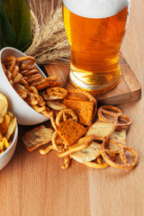 Lager beer and snacks on stone table. Cracker, chips side view