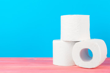 Toilet paper stack on bright blue background