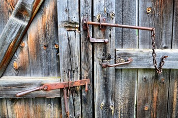 Ural village Tirlyan, Russia. Homemade bolts on wooden gates in an old house.