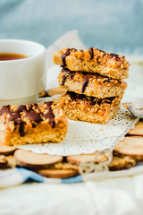 Granola bar with date caramel and chocolate. Healthy sweet dessert snack. Cereal granola bar with nuts, fruit and berries. Healthy breakfast.