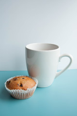 Tea with muffins with chocolate drops. Delicious sweet dessert. Sweetness to tea. Homemade baking. Treats for children. Popular cupcake.