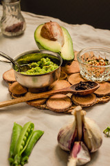 Sauce with avocado (guacamole), with sweet green peas in a metal container. Selective focus.