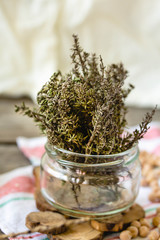 Dried sprigs of rosemary in a jar. Spicy grass. Seasoning.