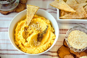 Traditional Middle east appetizer Hummus served with herbs, seasoned with in vintage ceramic plate....