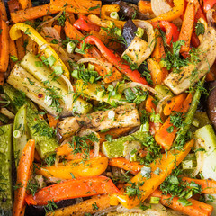 Vegetarian vegetable casserole close up, healthy food - potatoes, peppers, tomatoes, onions, garlic, eggplant, zucchini