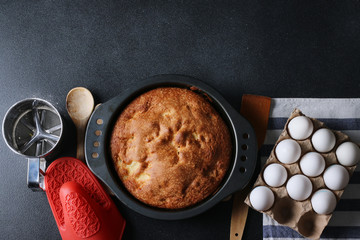 biscuit pie with ingredients top view on dark background close up