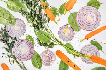 background with carrots, red onions, spices and spinach leaves