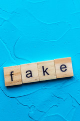 inscription on a blue background fake news. Concept. Vertical photo
