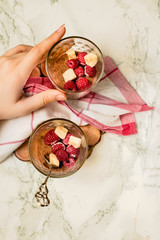 Homemade Dark Chocolate Mousse with banana and berries. Diet detox food concept.The process of eating. In the hands of a young woman.Top view.