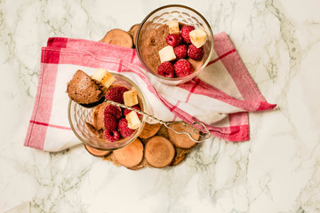 Chocolate chia pudding in portion glasses on a white marble table. Comfort food concept.Top view.